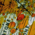 An extreme close-up of a document viewed through orange fluid.