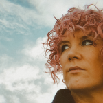 A photograph of Tracy Bruen. She has pink, chin-length hair.