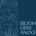 A graphic with light-blue text at the top reading 'BÍODH ORM ANOCHT'. The bottom half of the image is a design comprised of a triple spiral and other patterned lines and shapes, arranged into an upper and a lower arc. The design is light-blue against a dark-blue background.