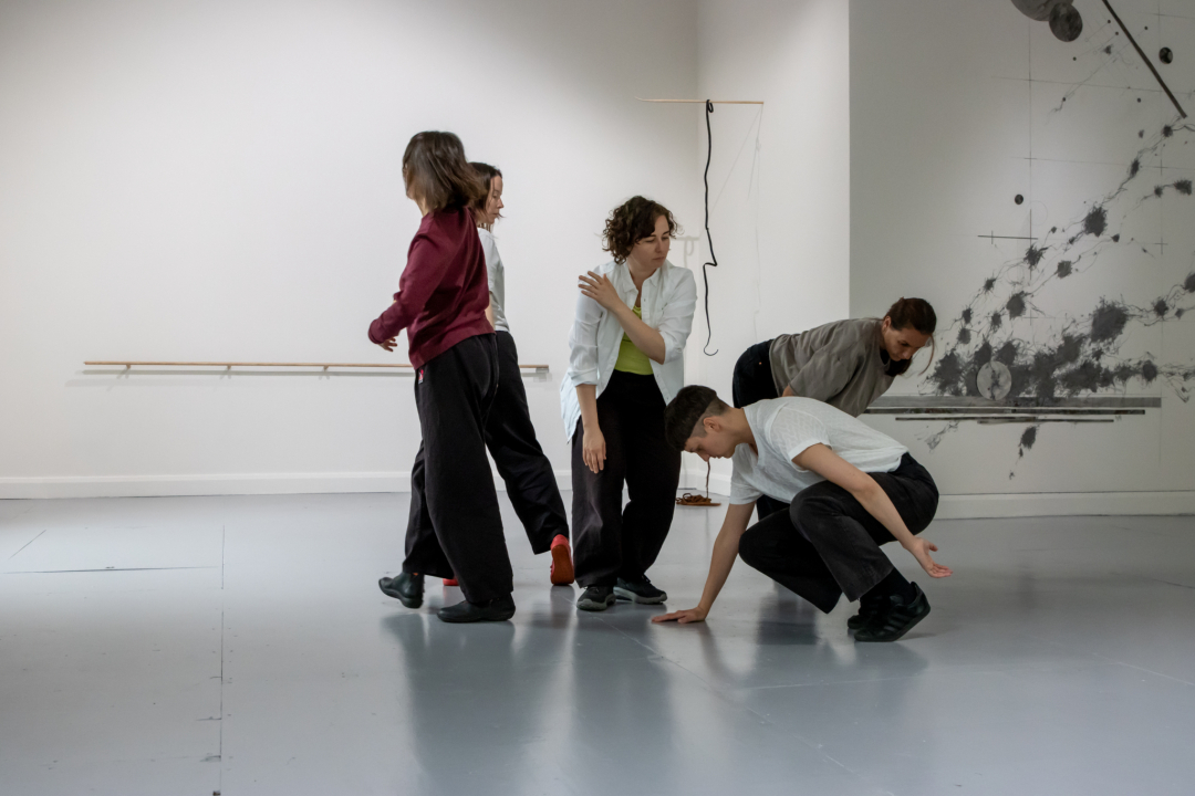 In Ormston House, the five members of The Parsley Collective stand in a tight circle in various positions.