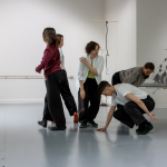 In Ormston House, the five members of The Parsley Collective stand in a tight circle in various positions.